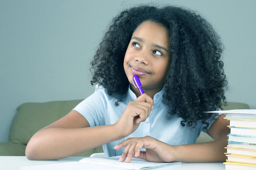 Portrait of a Little Girl Studying on the Table