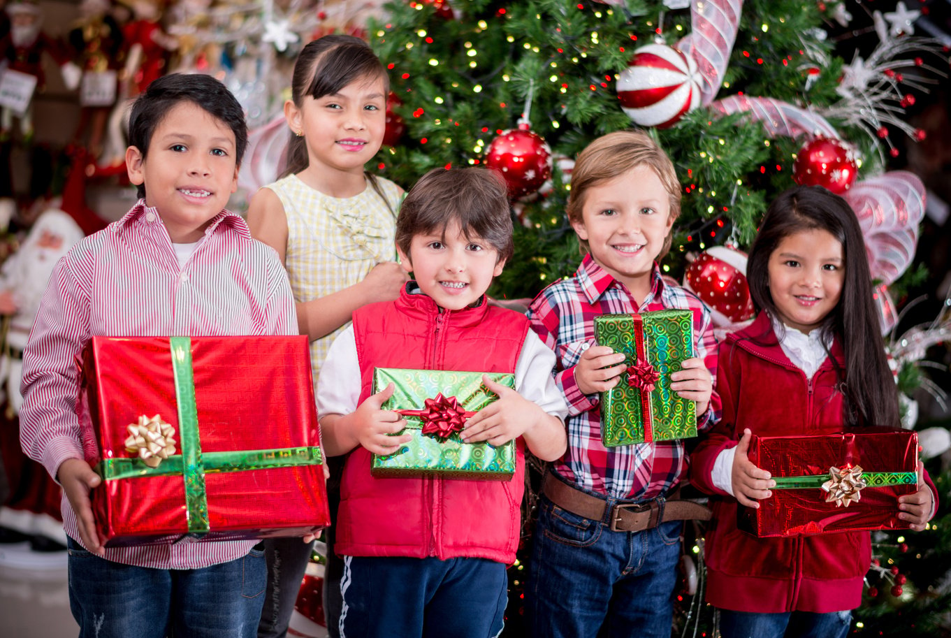 Kids holding Christmas presents